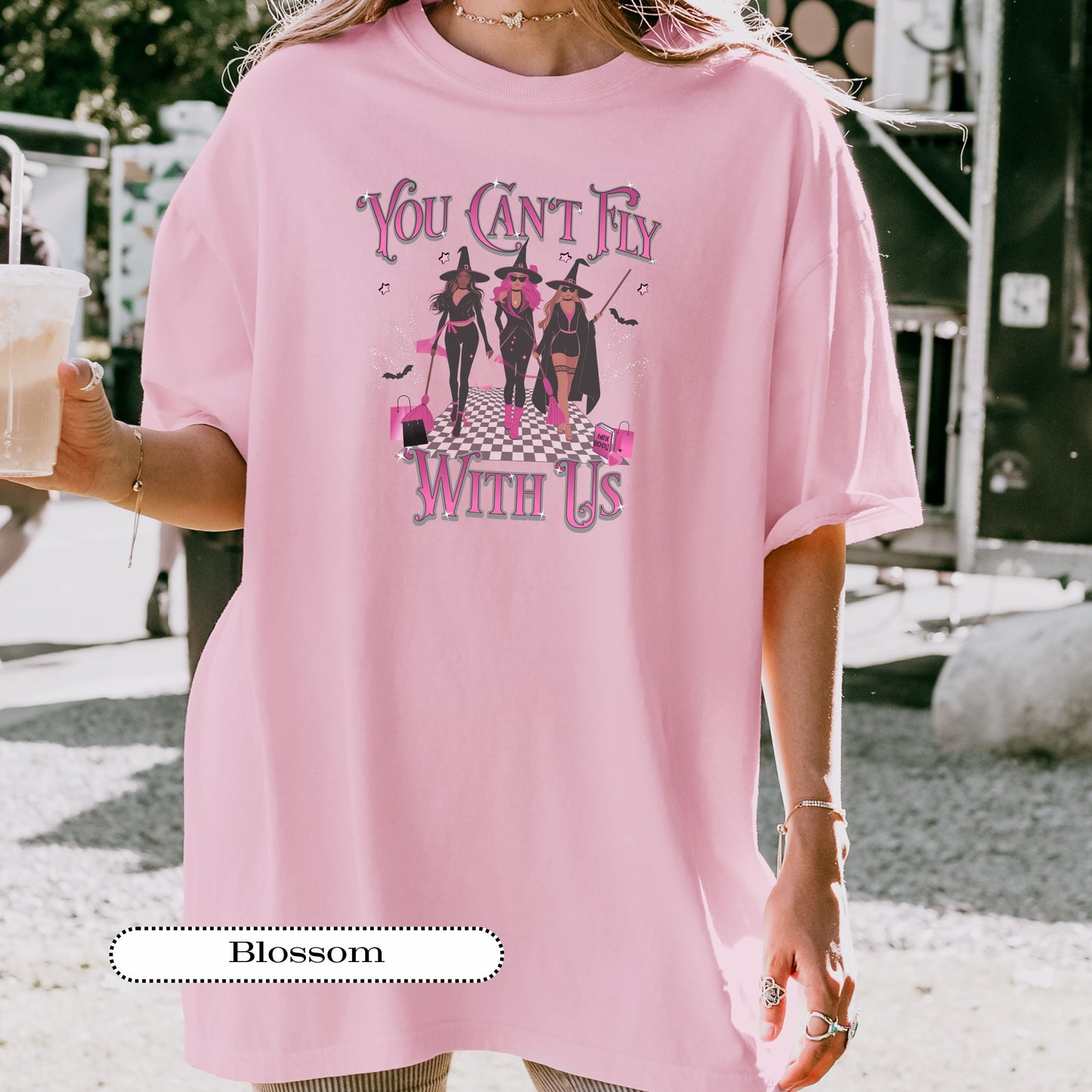 Witchy girl gang t-shirt featuring three witches in black and pink outfits holding brooms