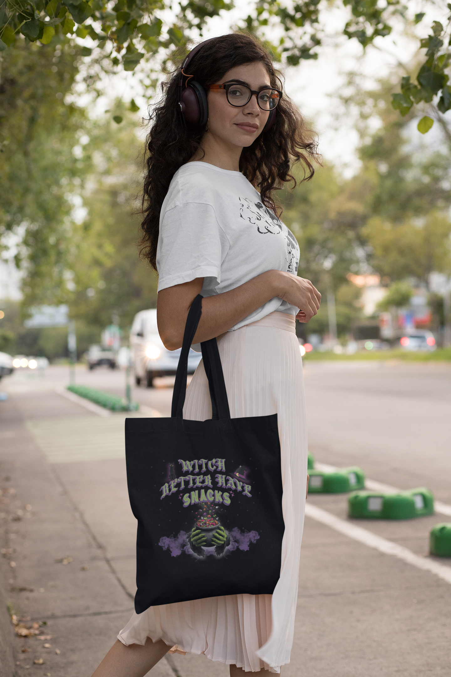 Funny witch tote bag with candy and magical sparkles rising from cauldron