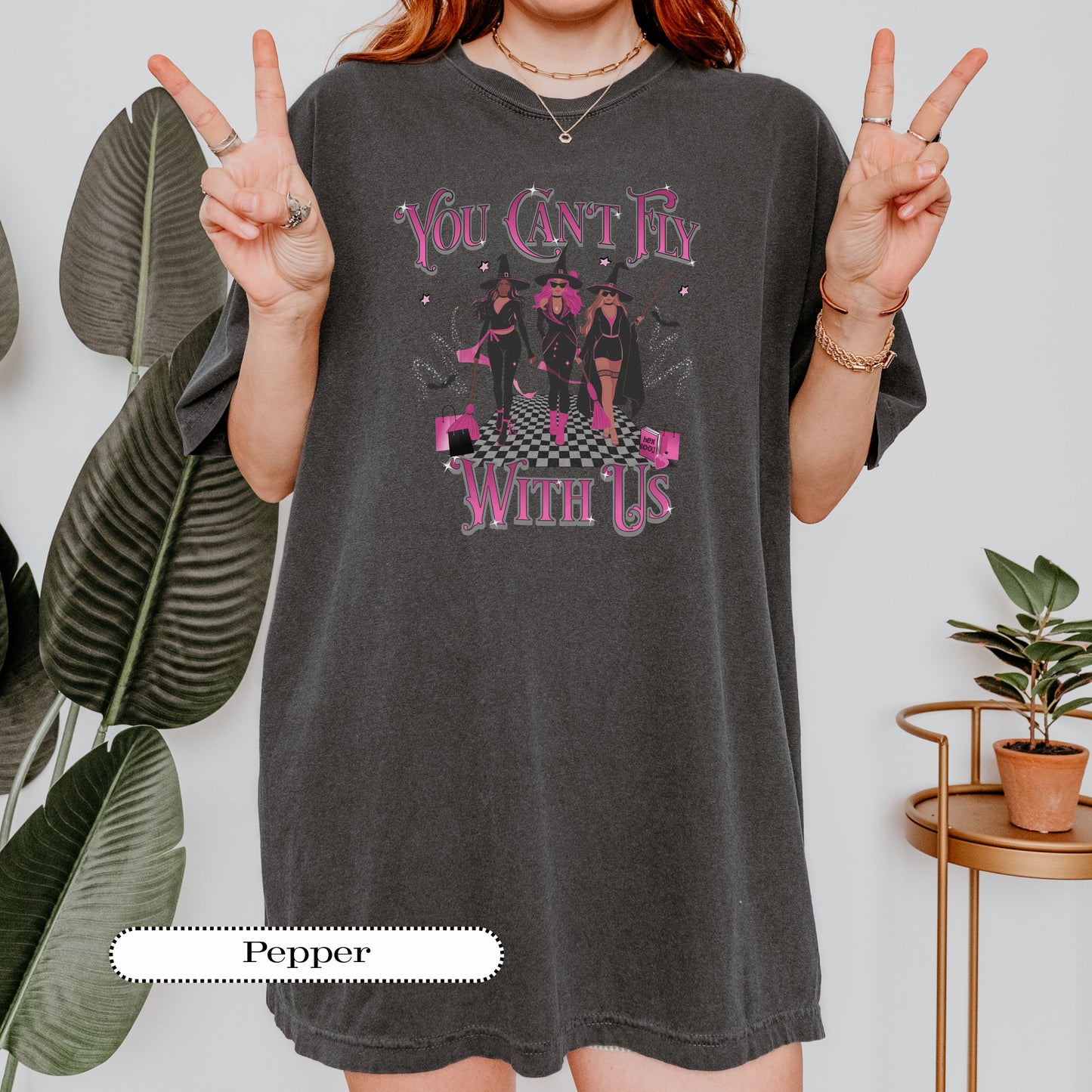 Pepper Comfort Colors® tee with “You Can’t Fly With Us” witch squad graphic in pink and white