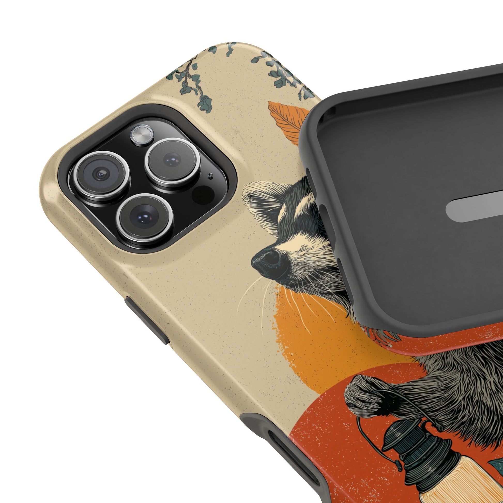 Raccoon lantern phone case displayed on desk with fall leaves